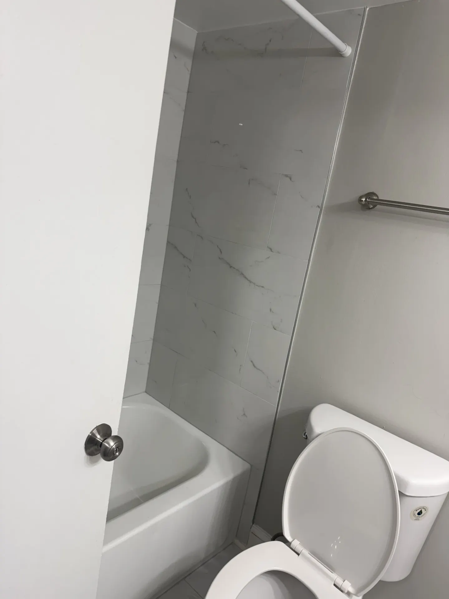 Updated bathroom with new tile shower surround and grab bar
