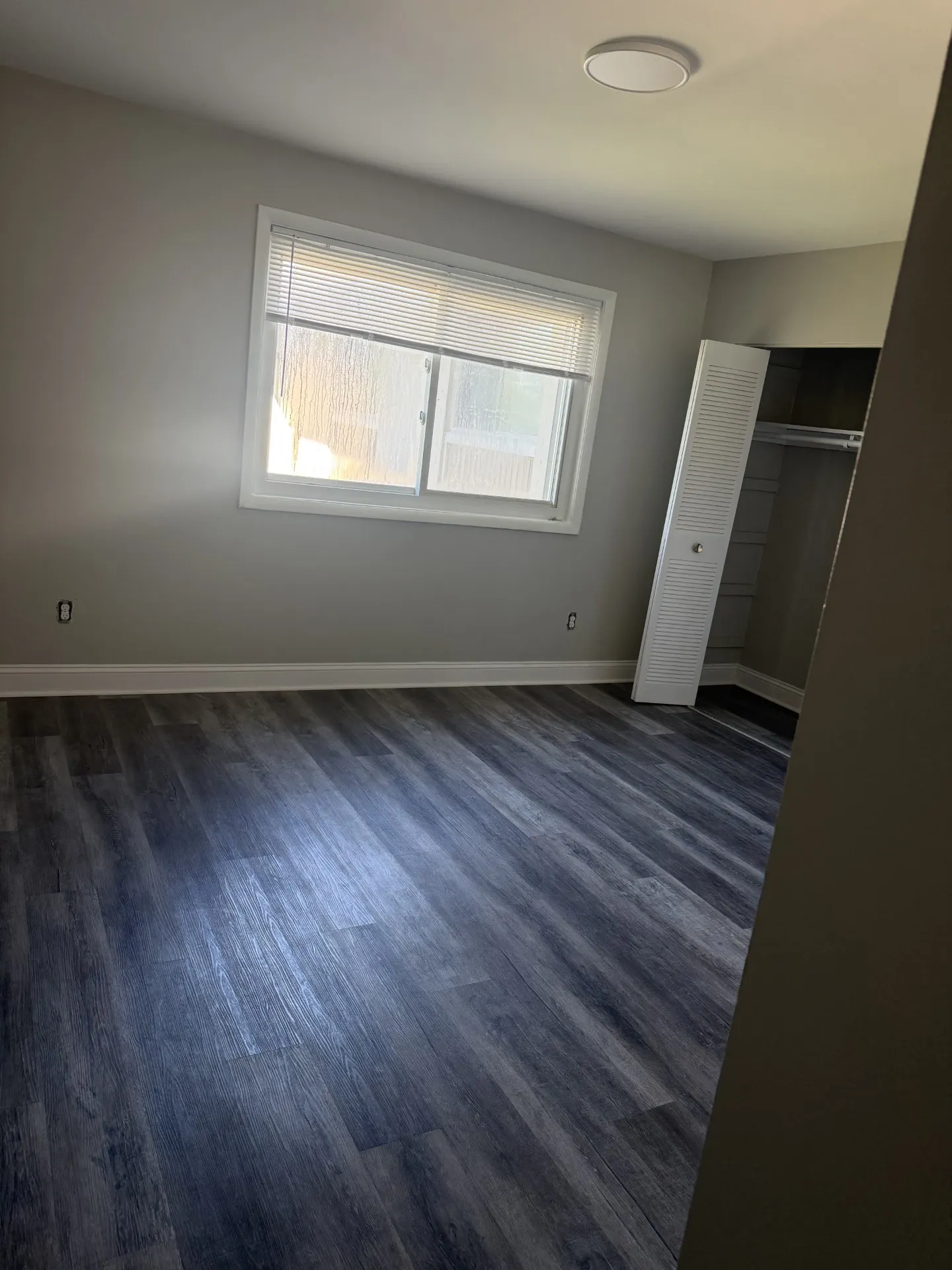 Second bedroom with new flooring and closet space