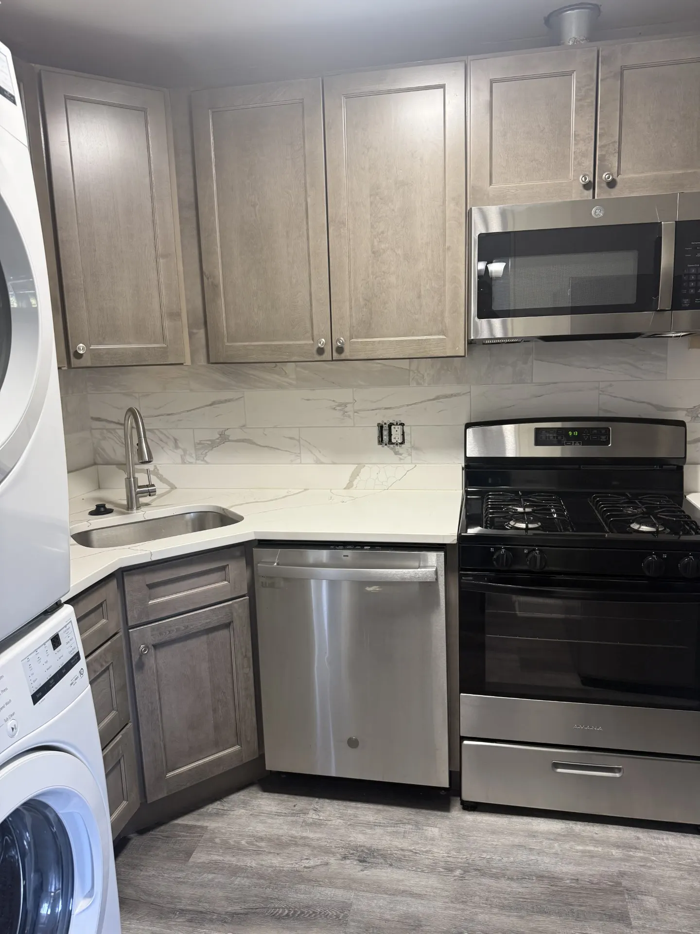 Renovated kitchen with new cabinets, countertops, and stainless appliances
